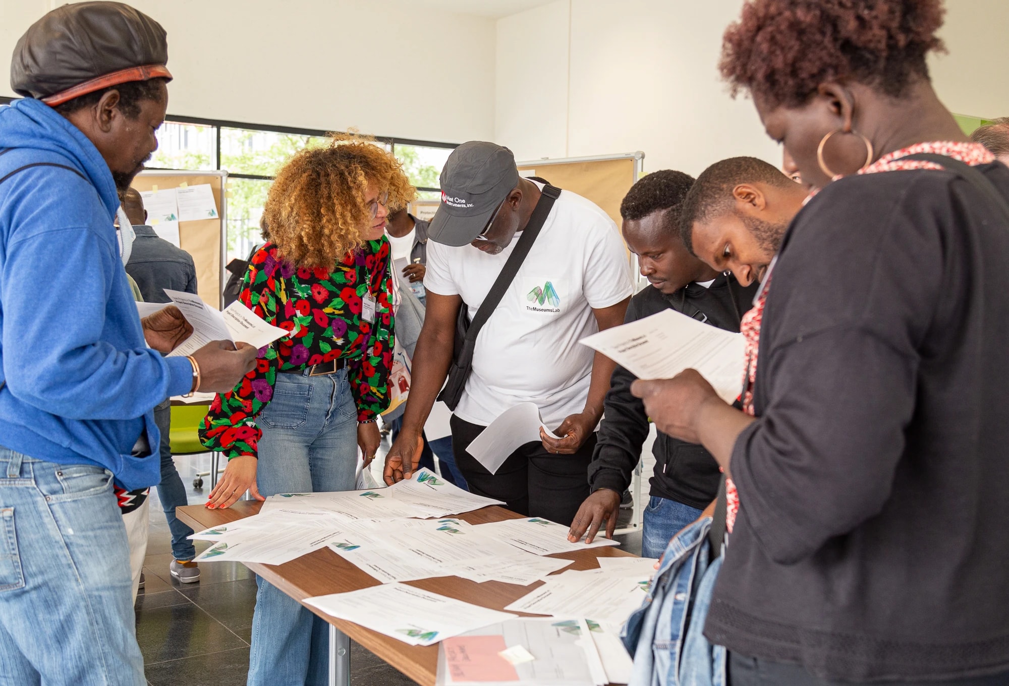 six people looking at different texts during workshop