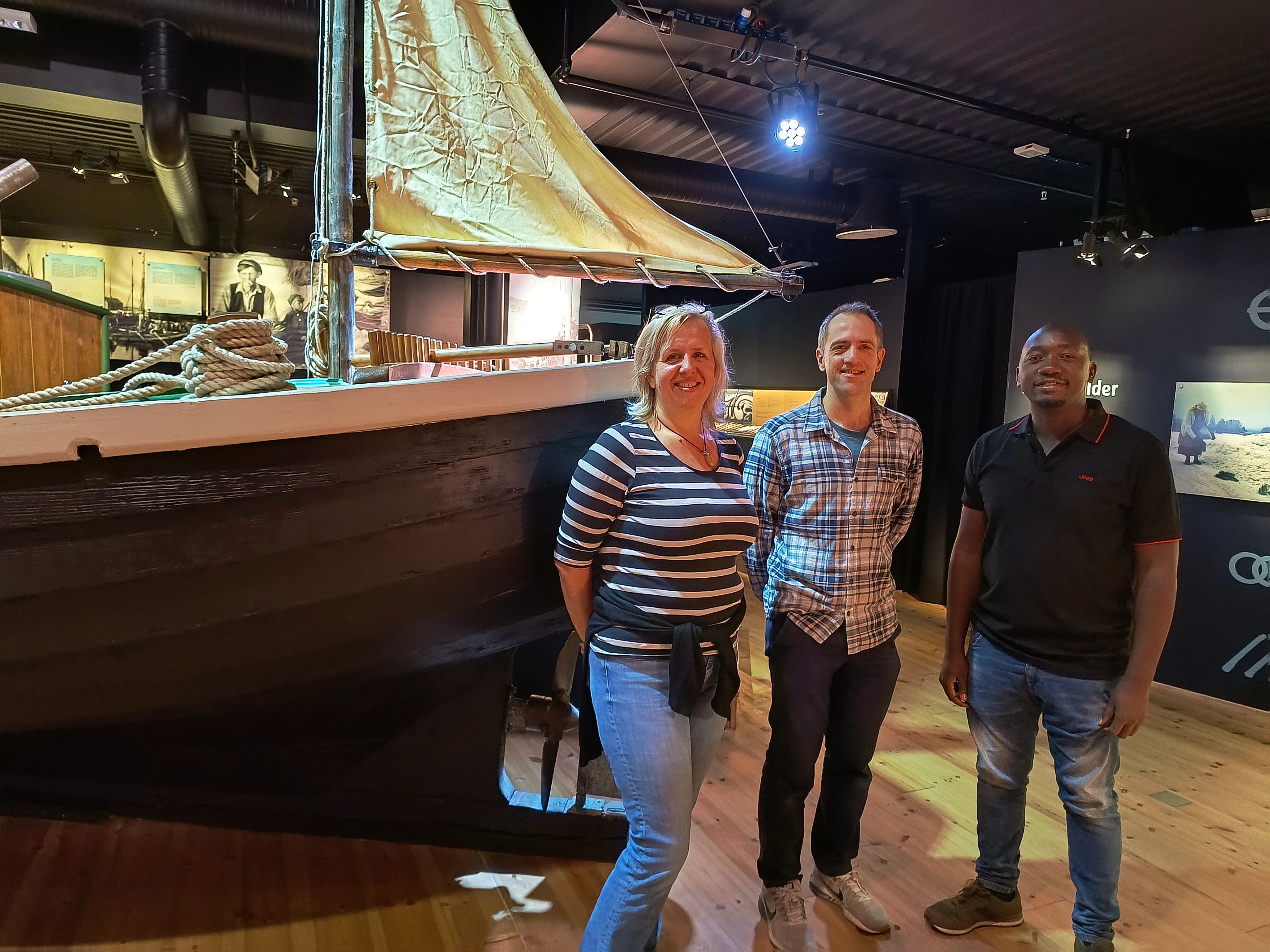 Panni, Aliguma and Sigurd in front of a ship in the Glomdal Museum exhibition