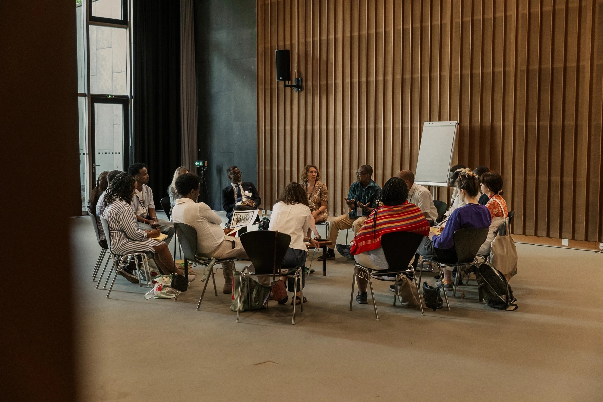 by Aja Dotson Photography group sitting in a circle during a workshop at HKW